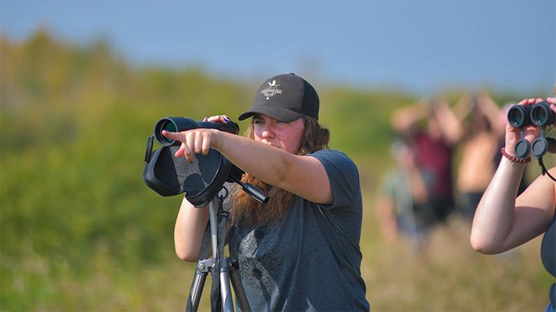 Students using binoculars while birding