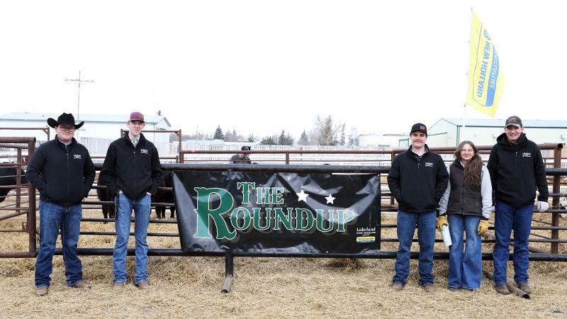 Students next the The Round Up sale banner