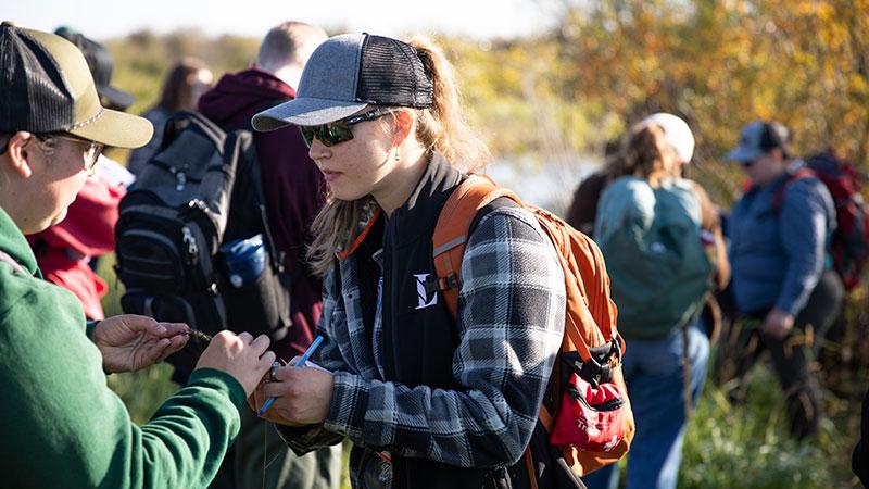 Student and instructor identifying vegetation during a riparian management lab